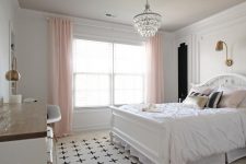 a refined teen girl bedroom in black, white and blush, with a large comfy bed, a crystal chandelier and touches of brass