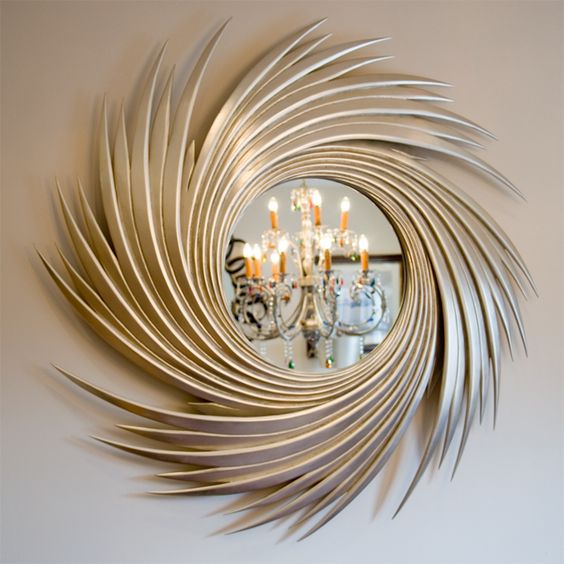 a round mirror in a fantastic metallic frame that reminds of the grass is a chic and shiny idea for a modern space