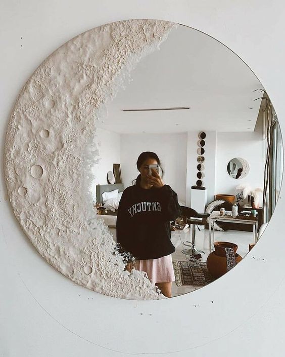 a round mirror with lunar decor is a fantastic idea for a boho space, it will add a celestial touch to the room
