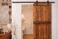 a rustic sliding barn door is a cool idea to cozy up the space