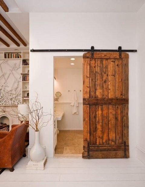 a rustic sliding barn door is a cool idea to cozy up the space