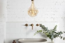 a single large bulb pendant lamp with a brass base is a cool and stylish modern idea to rock