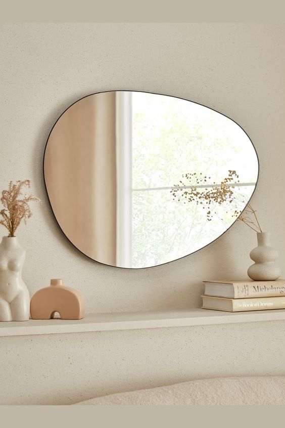 a soft pebble-shaped wall mirror will be a nice idea for a mid-century modern or Scandi space, it will be in harmony with the shapes around