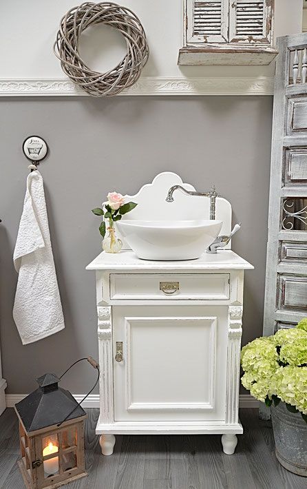 a vintage white cabinet or a nightstand can become a lovely and chic vintage bathroom vanity with plenty of storage space inside