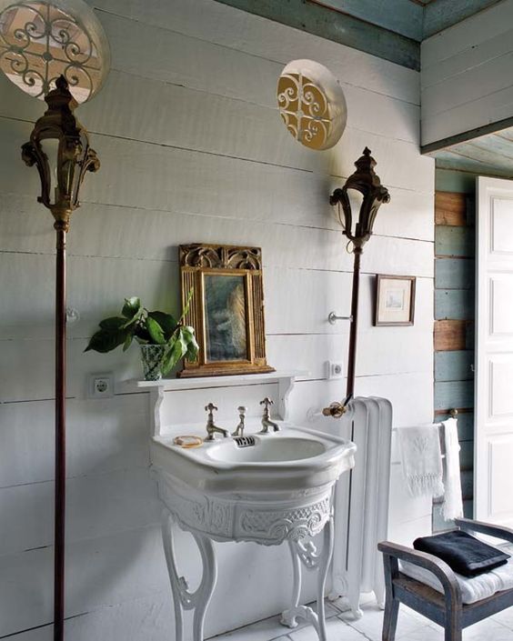 a vintage white sink stand like this one adds a sophisticated and chic touch to the space and it can be DIYed
