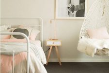 a welcoming teen girl bedroom in off-white, grey and light pink, with a pendant chair and printed bedding