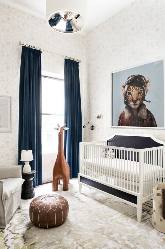 a whimsy modern nursery decorated with a leather ottoman, a large toy giraffe, an artwork and rugs