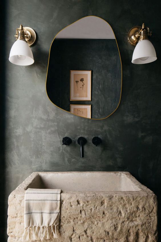 an irregularly shaped and asymmetric mirror in a brass freame is a great idea for many bathrooms, it will instantly give a unique touch to the space