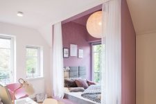 an ultra-modern and bold teen girl bedroom with a purple alcove sleeping space byt the window and a white studying zone