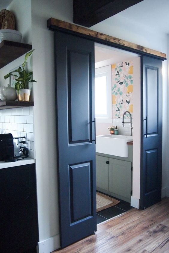 navy double barn doors with handles welcome entrance to the laundry and add a rustic feel