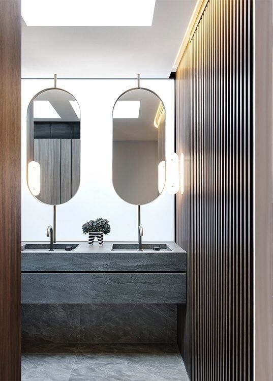 oval-shaped wall lamp like this one resembles of the mirror shape and looks very chic and very bold