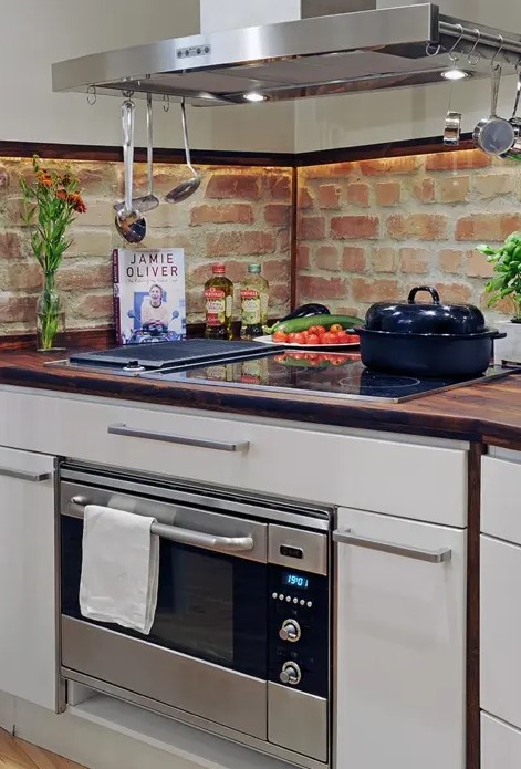 a red brick backsplash is a catchy idea for any kitchen, besides it's very budget-friendly and adds texture