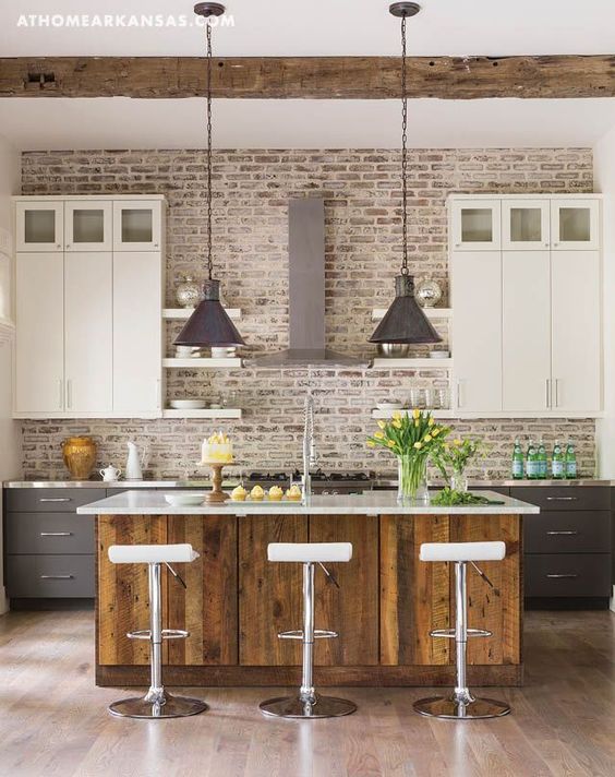 a two-tone kitchen with white and graphite grey cabinets, a whitewashed brick backsplash, a stained kitchen island with a white countertop