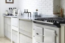 a white brick wall perfectly matches the Nordic kitchen and adds texture and interest to it