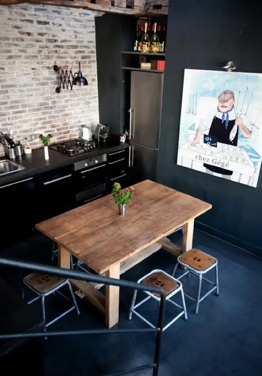 a whitewashed brick wall contrast the matte black cabinets and add texture to the space