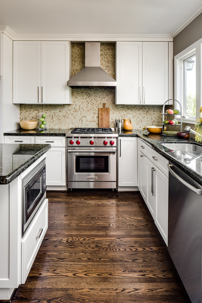 A kitchen island with a built-in microwave and a gorgeous black countertop. (Robin Heard Design)