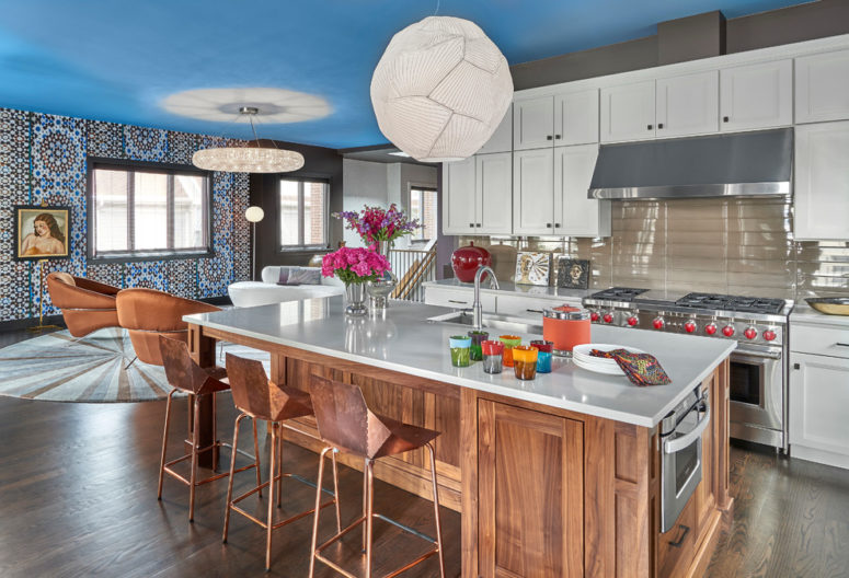 A gorgeous kitchen island in an open space with a built-in microwave. (Mitchell Channon Design)