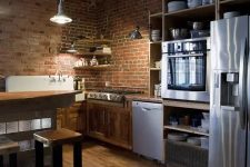 red brick walls match the rich stained wood and add texture and interest to the kitchen