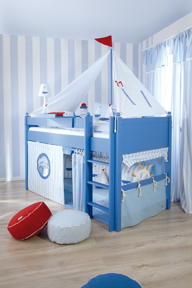 Shaped like a sailboat, this bed features a cozy play area under it. (The Baby Cot Shop)