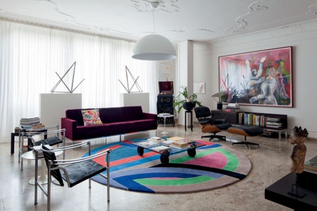 The living room delivers the refined taste of the owners   LC1 armchairs (1928) by Le Corbusier, Pierre Jeanneret and Charlotte Perriand, Cassina sofa (1954), Florence Knoll, and pendant Skygarden