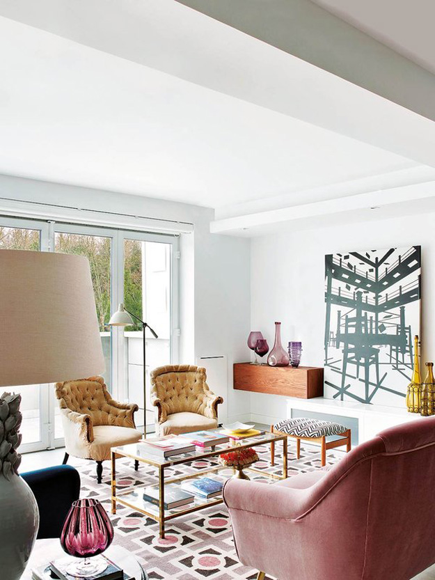 The living room is serene and inviting due to the glazed wall and a warm color palette