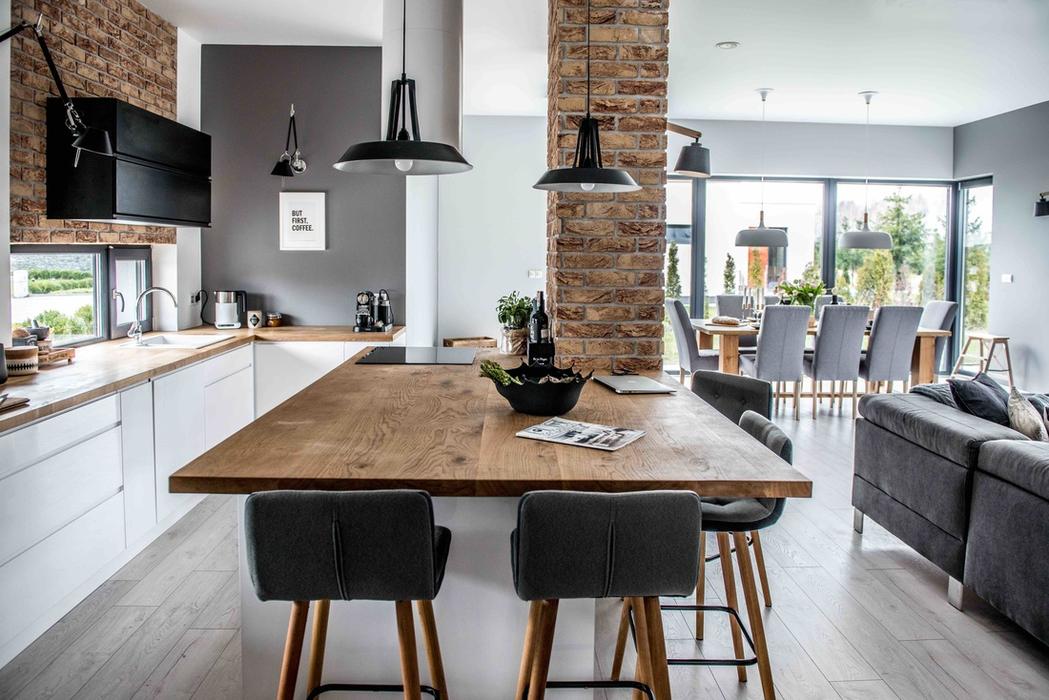 This living room, dining area and kitchen was designed open plan but the area are well separated with furniture