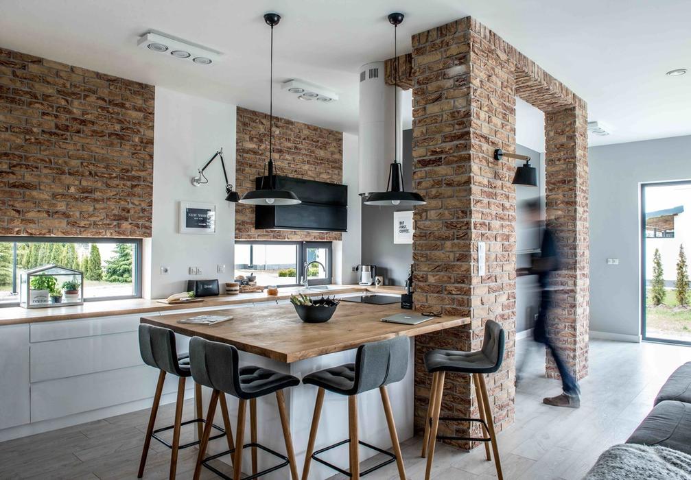 Brick gates or beams highlight the kitchen, and various shades of grey create an effect of optical depth