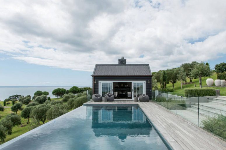 Modern deck with a large swimming pool and a glass fence looks cool