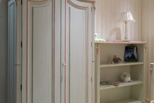 03 Luigina wardrobe with a pink trim and a storage shelf with floral edges