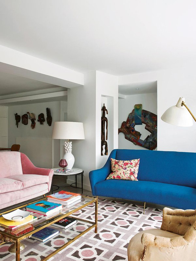 The walls are kept white not to distract attention from the bold African art collection