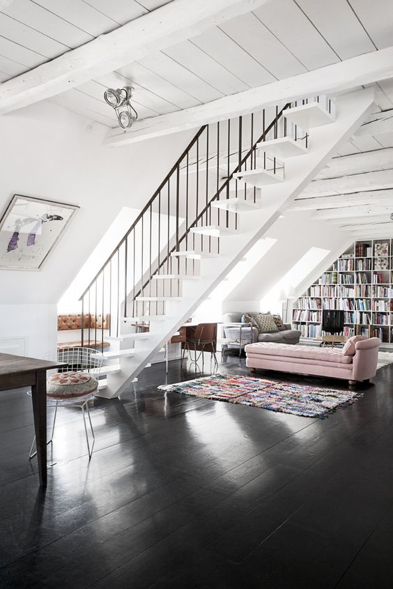 black polished wooden floors contrast with white walls