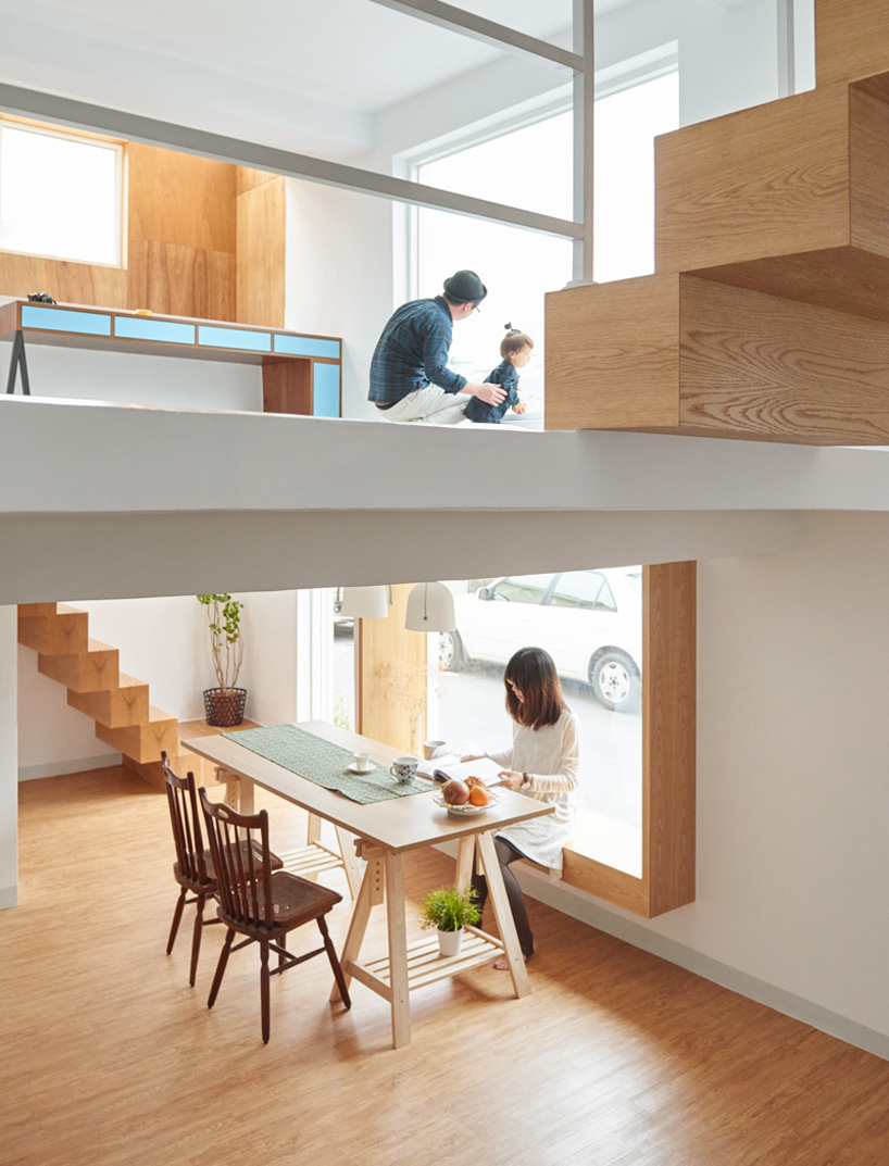 The large window frame is also used as a seating for the dining area