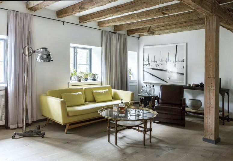 Most of the furniture in the living room was bought as flea markets and antique shops except for the sofa. Exposed beams  are very noticeable here too.