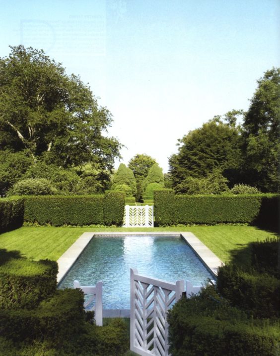 05 green hedge with white wooden gates to keep the pool private