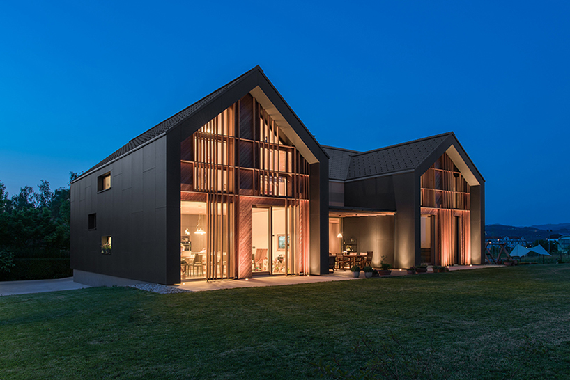 There's a terrace between the two volumes and extensive glazing with wooden screens allows connection with nature with enough privacy