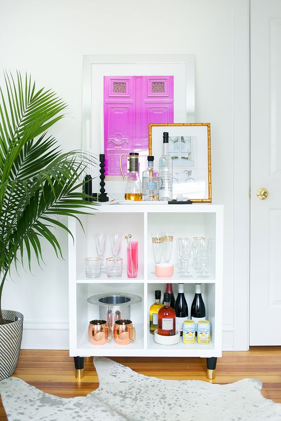 an IKEA Kallax home bar with gilded legs, with decor and all the necessary bar stuff is a perfect idea if you need a bar