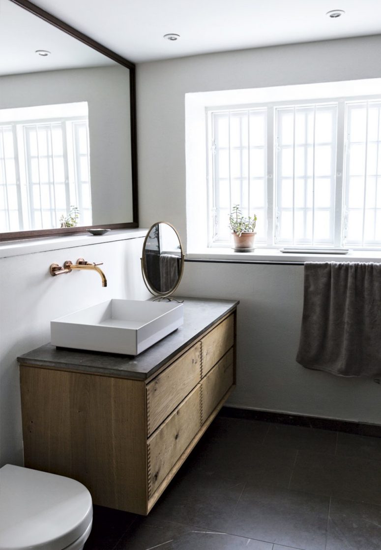 The bathroom is on the ground floor and has windows to let the light in