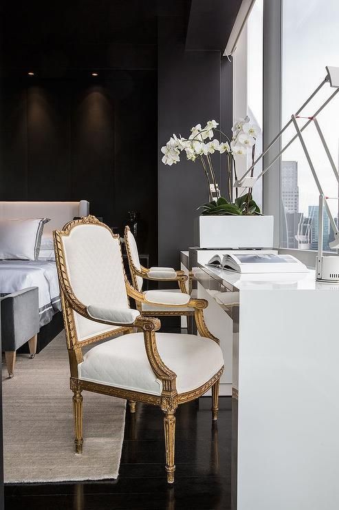 modern black and white bedroom with a workspace by the window