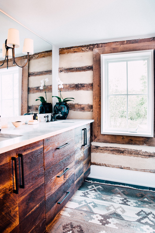 The master bathroom is clad with rough wood and the furniture is covered with the same wood also