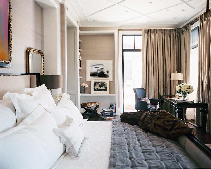 an art deco bedroom with a stylish black desk and leather chair in the corner