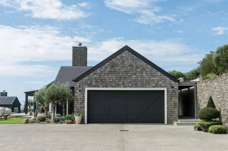 Some parts of the house are covered with weathered wood to achieve that barn look