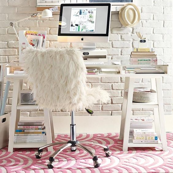 white acrylic desk with storage tops in front of a white brick wall