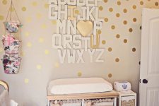 13 white and gold changing table with a cool alphabet art over it