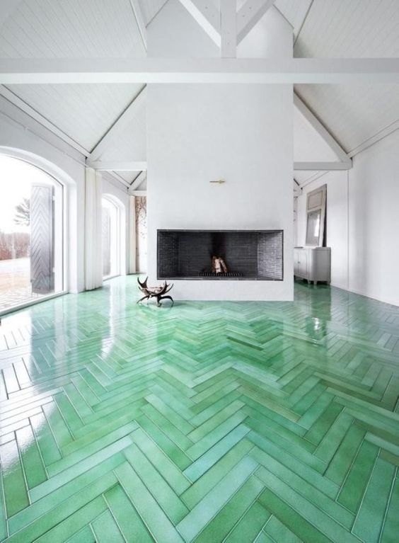 19 green herringbone wooden floors are a bold decoration feature in this white room