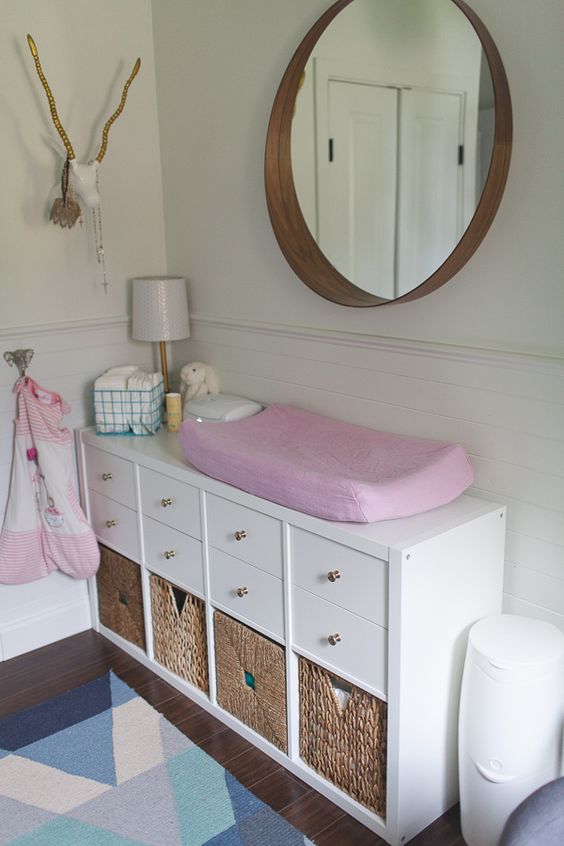 an IKEA Kallax turned into a comfy changing table with cubbies is a very smart and functional solution for any kids' room