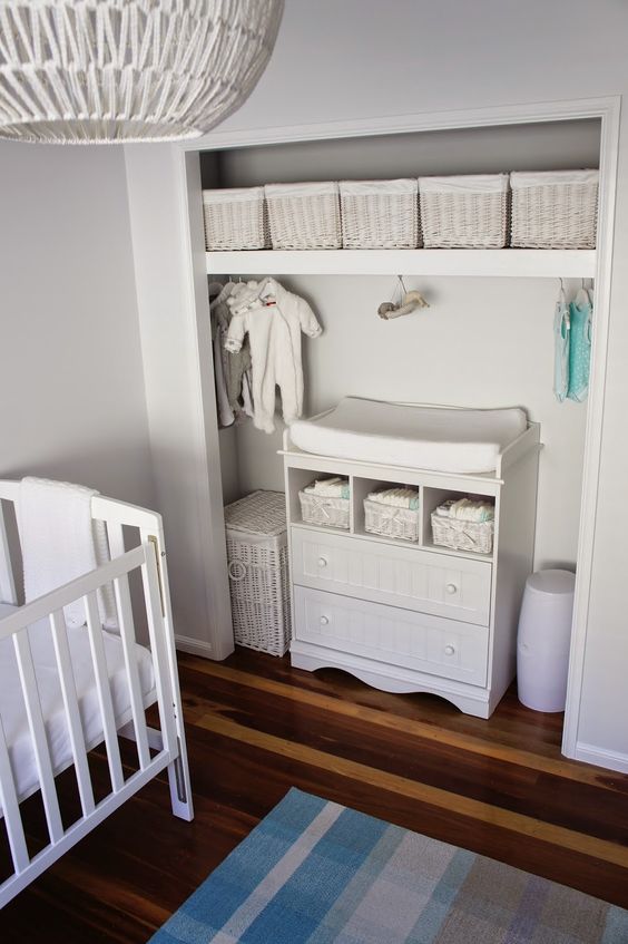 all-white closet changing table and cubbies for storage