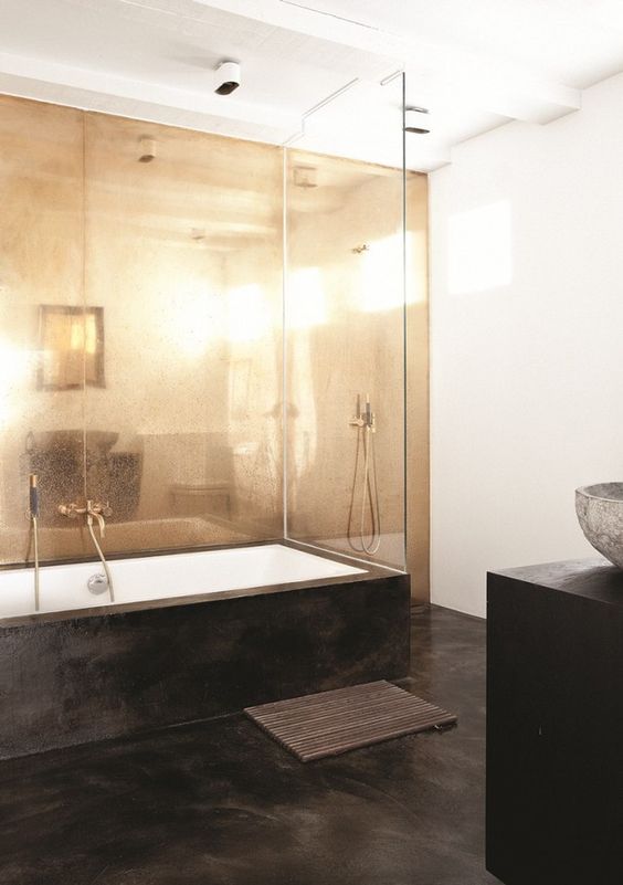 26 sleek black concrete floors to contrast with a brass wall