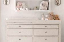 27 simple pastel changing table with storage shelves over it