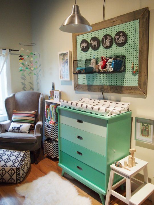 ombre mint changing station with a pegboard storage above it