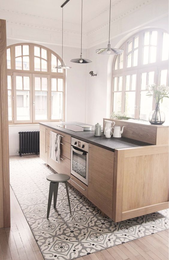 29 mosaic floor tiles under the kitchen island and wooden floors around